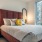 a bed with a mirror above it