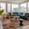 a living room with a green couch and a large window